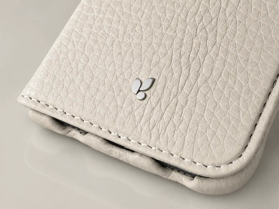 Macro of the machined metal Vaja mark set into the leather of a Duo case